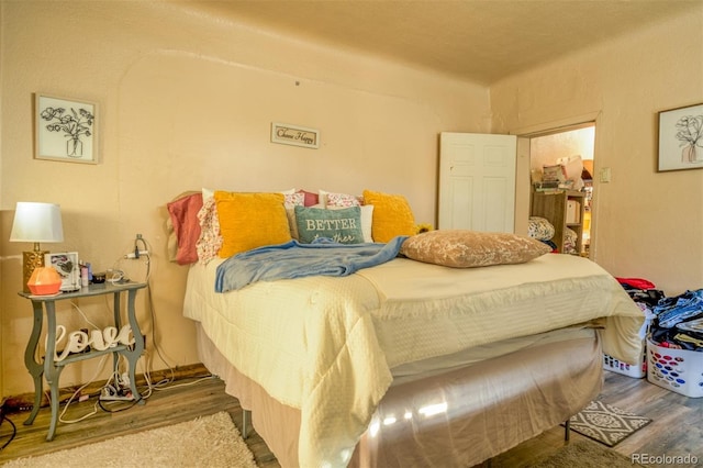 bedroom with wood-type flooring