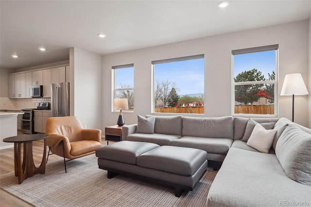 12283 W 57th Ln, Arvada, CO 80002 - living room featuring recessed lighting and light wood-style flooring