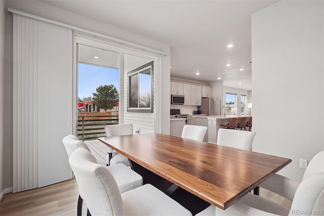 12283 W 57th Ln, Arvada, CO 80002 - dining room featuring light wood finished floors and recessed lighting