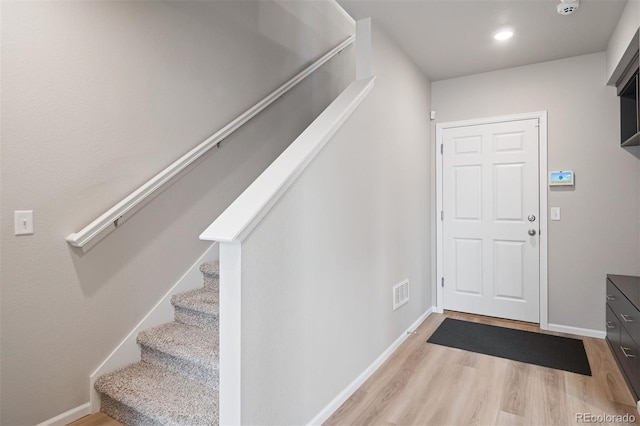 12283 W 57th Ln, Arvada, CO 80002 - entrance foyer featuring wood finished floors and stairway