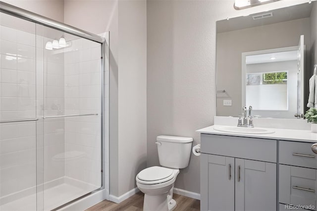 12283 W 57th Ln, Arvada, CO 80002 - full bathroom with a stall shower, vanity, and wood finished floors