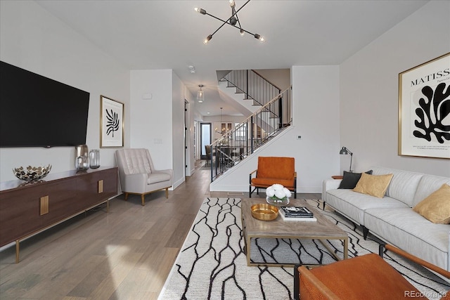 living room featuring wood-type flooring and a chandelier