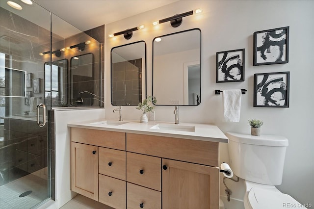 full bath featuring double vanity, toilet, a stall shower, and a sink