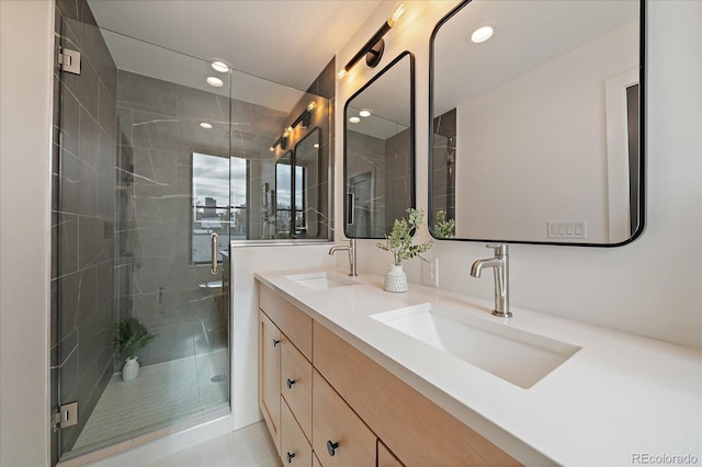 bathroom featuring a sink, double vanity, recessed lighting, and a shower stall