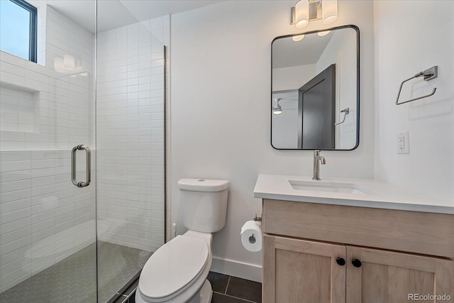 full bathroom with a shower stall, baseboards, toilet, tile patterned floors, and vanity