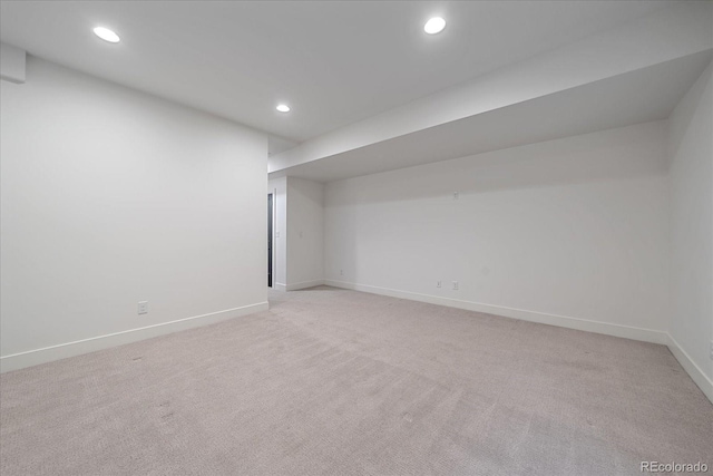 finished basement with recessed lighting, baseboards, and light carpet