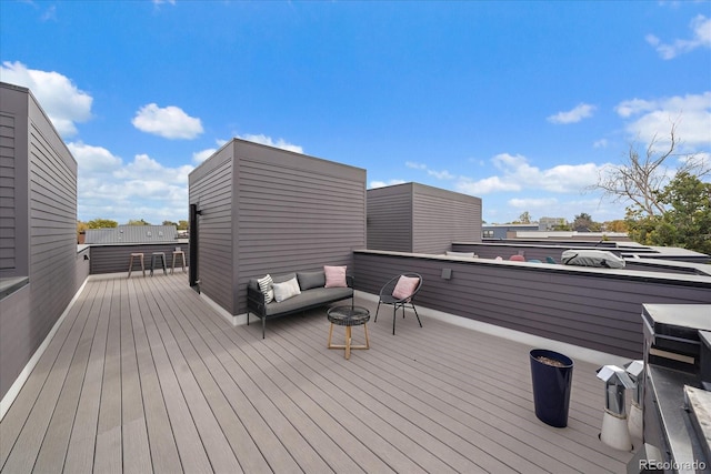 wooden terrace featuring an outdoor living space