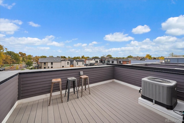 wooden deck featuring a residential view and central AC