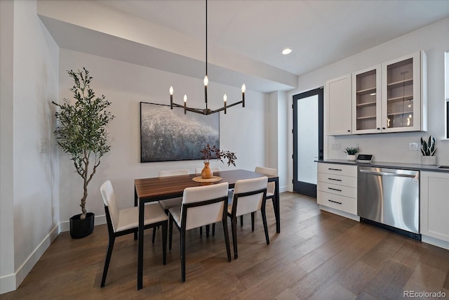 dining area with an inviting chandelier, recessed lighting, baseboards, and dark wood-type flooring