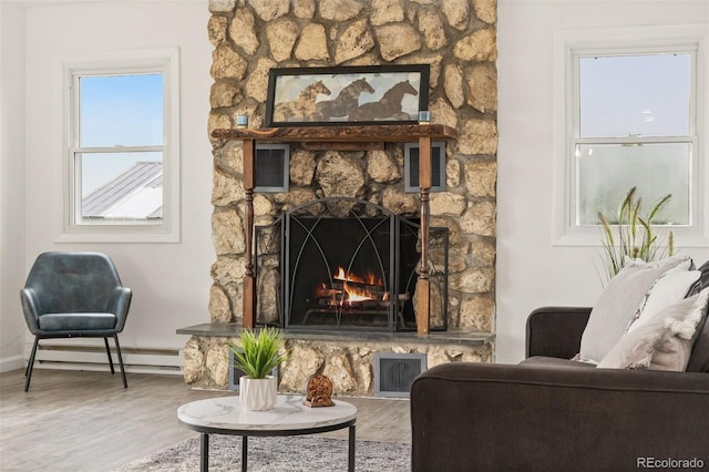 14475 Lanewood St, Brighton, CO 80603 - living room featuring baseboard heating, wood finished floors, and a fireplace