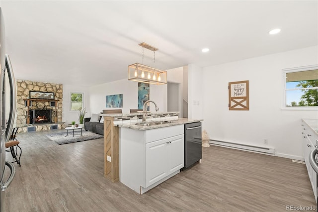 14475 Lanewood St, Brighton, CO 80603 - kitchen featuring a baseboard radiator, appliances with stainless steel finishes, light wood finished floors, plenty of natural light, and recessed lighting