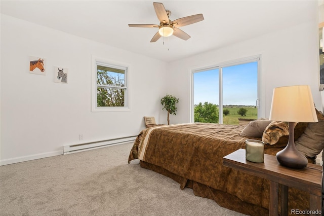 14475 Lanewood St, Brighton, CO 80603 - carpeted bedroom featuring a baseboard radiator, multiple windows, and a ceiling fan