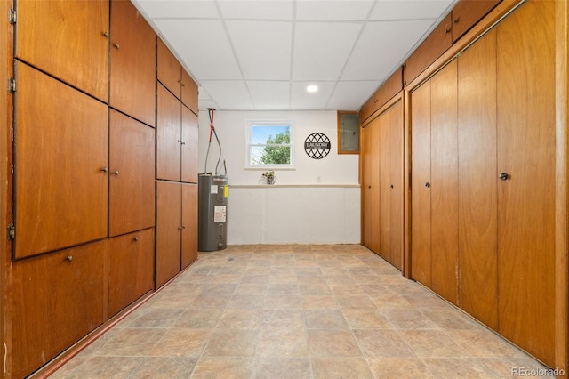 14475 Lanewood St, Brighton, CO 80603 - corridor with water heater, a paneled ceiling, and electric panel