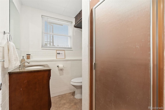 14475 Lanewood St, Brighton, CO 80603 - full bath featuring vanity, tile walls, a stall shower, and a wainscoted wall