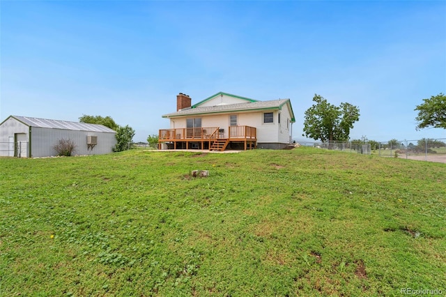 14475 Lanewood St, Brighton, CO 80603 - back of property with a deck, a chimney, and an outdoor structure