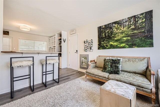 living room with baseboards and wood finished floors