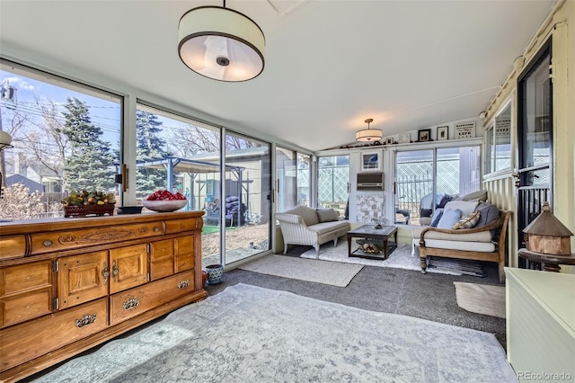 sunroom with cooling unit and vaulted ceiling