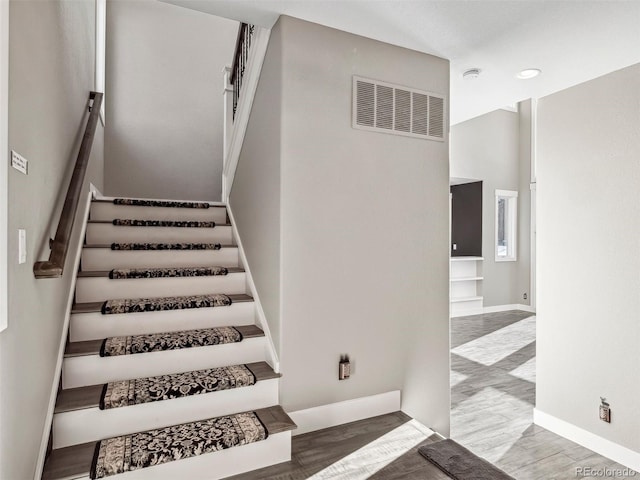 stairs with hardwood / wood-style flooring