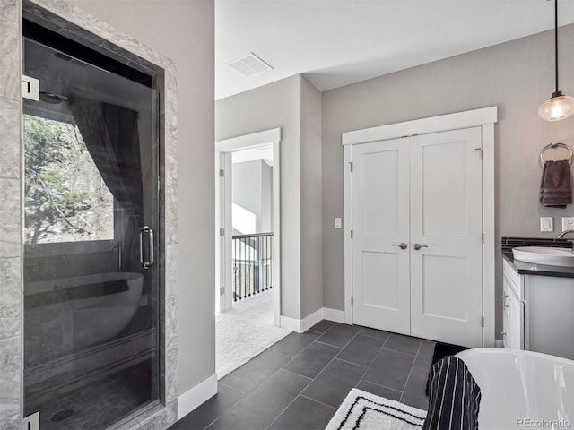 bathroom featuring tile patterned flooring, vanity, and independent shower and bath