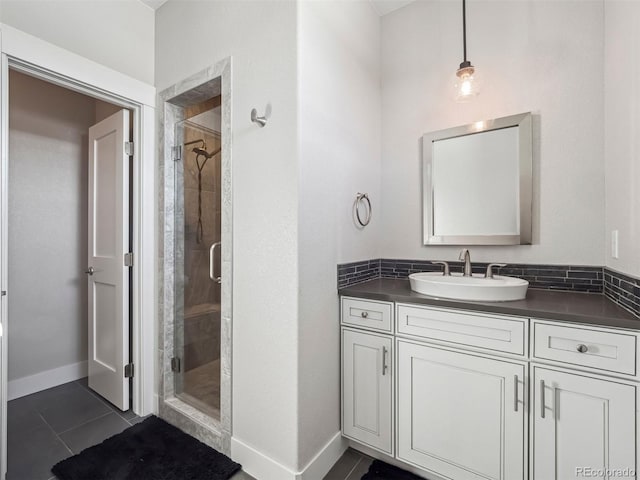 bathroom featuring tile patterned flooring, vanity, and walk in shower