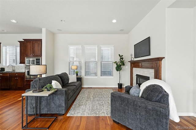 10368 Bluffmont Dr, Lone Tree, CO 80124 - living room featuring dark wood finished floors, recessed lighting, and a glass covered fireplace