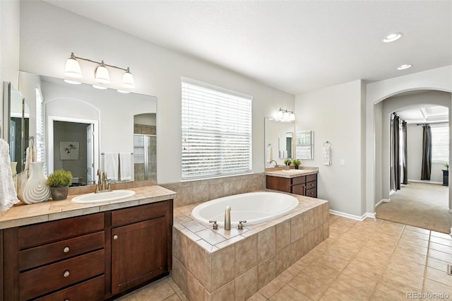 10368 Bluffmont Dr, Lone Tree, CO 80124 - full bathroom featuring a bath, two vanities, a stall shower, tile patterned floors, and recessed lighting