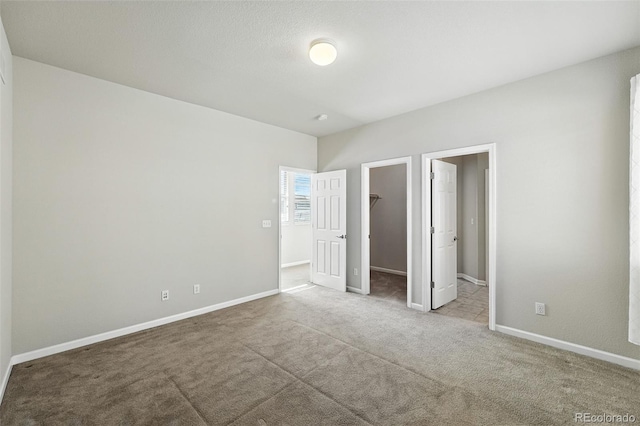 10368 Bluffmont Dr, Lone Tree, CO 80124 - unfurnished bedroom featuring carpet and a walk in closet