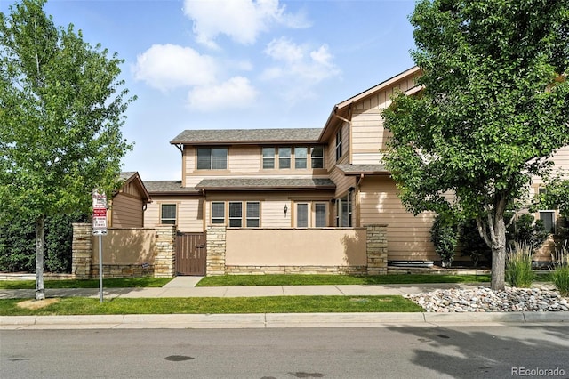 10368 Bluffmont Dr, Lone Tree, CO 80124 - view of front facade with a fenced front yard, a gate, and board and batten siding