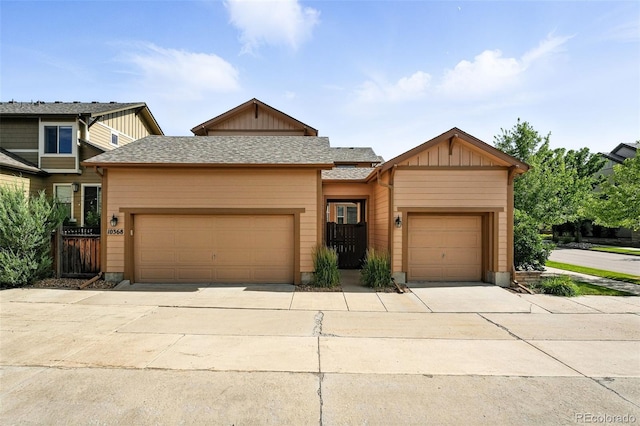 10368 Bluffmont Dr, Lone Tree, CO 80124 - view of front facade featuring a garage, board and batten siding, and driveway