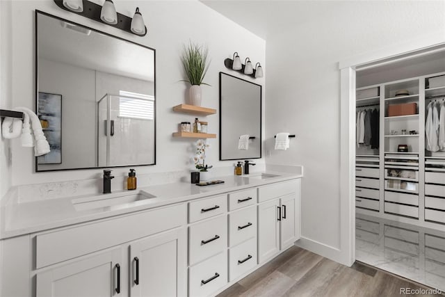 11187 W 53rd Dr, Wheat Ridge, CO 80033 - full bathroom with double vanity, a shower stall, and a spacious closet