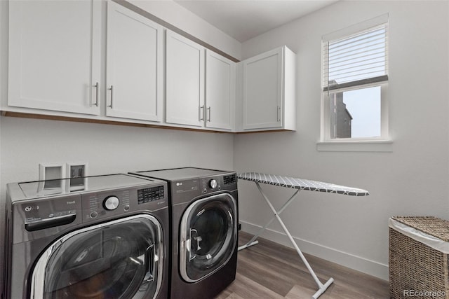 11187 W 53rd Dr, Wheat Ridge, CO 80033 - laundry area with light wood-style floors, cabinet space, and separate washer and dryer
