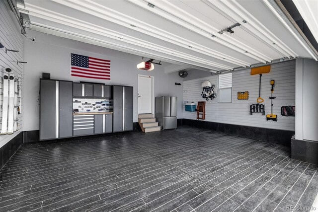11187 W 53rd Dr, Wheat Ridge, CO 80033 - garage featuring a garage door opener and freestanding refrigerator