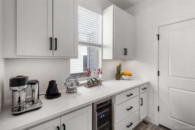 11187 W 53rd Dr, Wheat Ridge, CO 80033 - kitchen featuring beverage cooler and white cabinetry