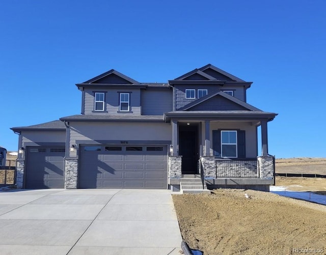 craftsman inspired home featuring covered porch and a garage