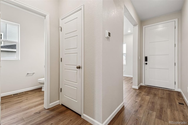 hallway with hardwood / wood-style floors