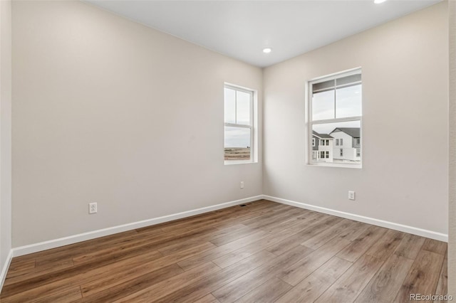 unfurnished room featuring light hardwood / wood-style floors