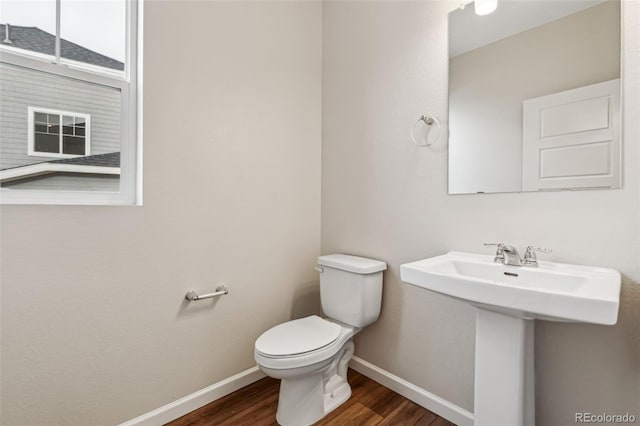 bathroom with hardwood / wood-style flooring, sink, and toilet