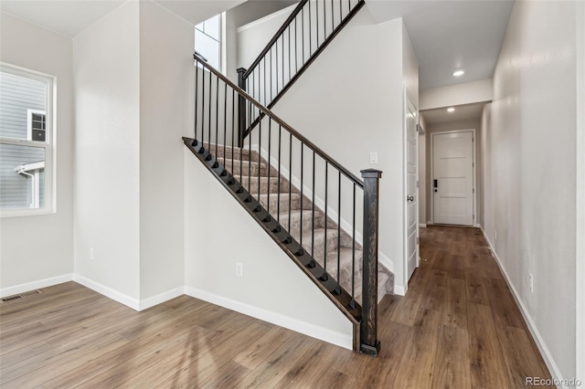 stairs featuring hardwood / wood-style flooring