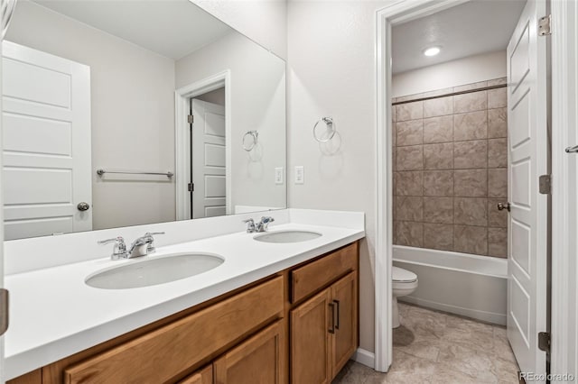 full bathroom with vanity, toilet, and tiled shower / bath combo