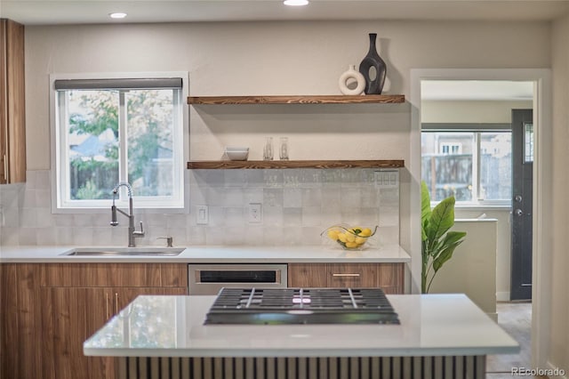 kitchen with dishwasher, sink, and tasteful backsplash