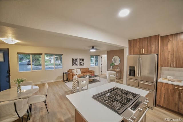 kitchen featuring light hardwood / wood-style floors, high quality fridge, ceiling fan, and a wealth of natural light