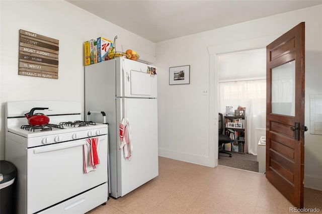 kitchen featuring white appliances, light floors, and baseboards