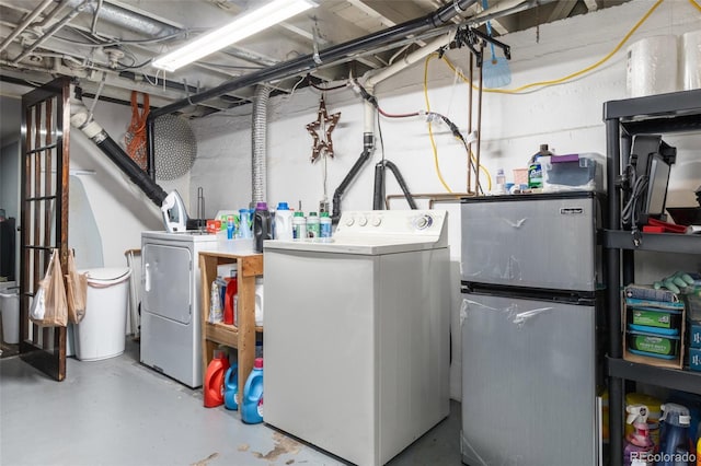 clothes washing area with washing machine and clothes dryer