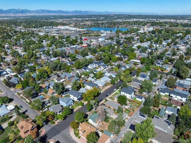 aerial view of property and surrounding area featuring a water and mountain view