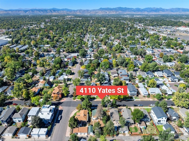 aerial view of property and surrounding area with a mountain backdrop and nearby suburban area