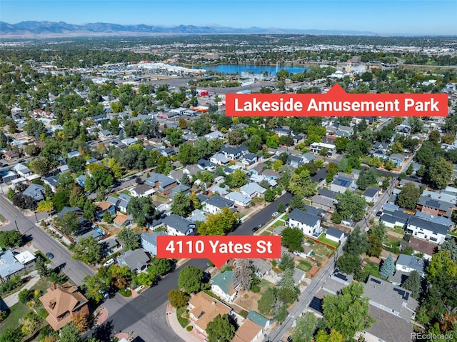 aerial overview of property's location with a water and mountain view and nearby suburban area