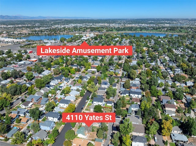 aerial view of property's location featuring a nearby body of water and nearby suburban area