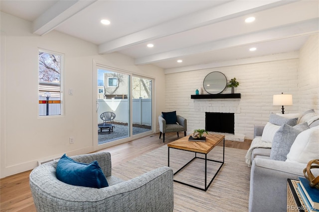 living room with beam ceiling, light wood-style flooring, recessed lighting, a fireplace, and baseboards