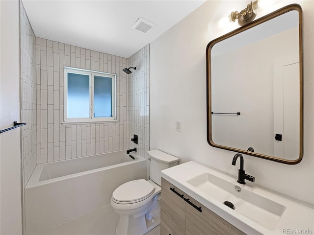 full bathroom with toilet, vanity, and tiled shower / bath