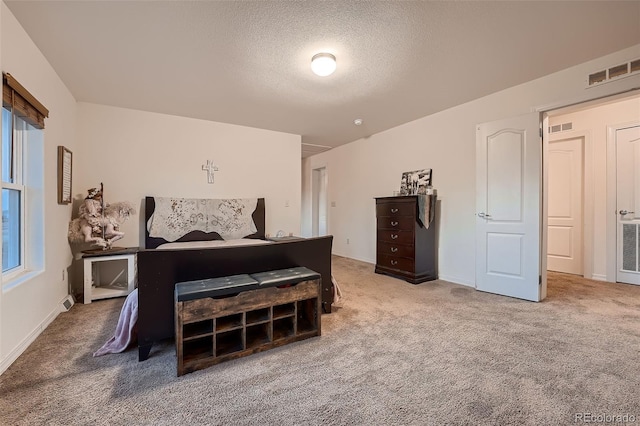 bedroom with carpet floors and a textured ceiling